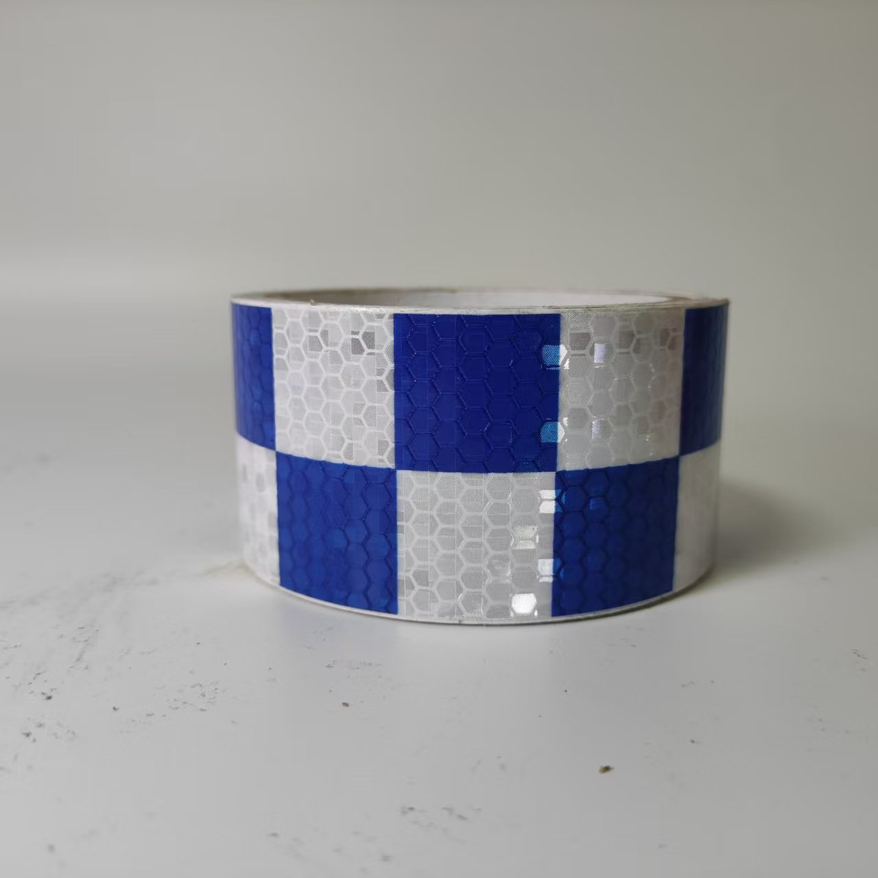 Blue and white checkerboard reflective tape roll