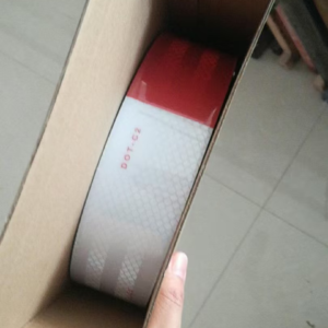 Single red and white DOT-C2 reflective tape roll in an inner carton