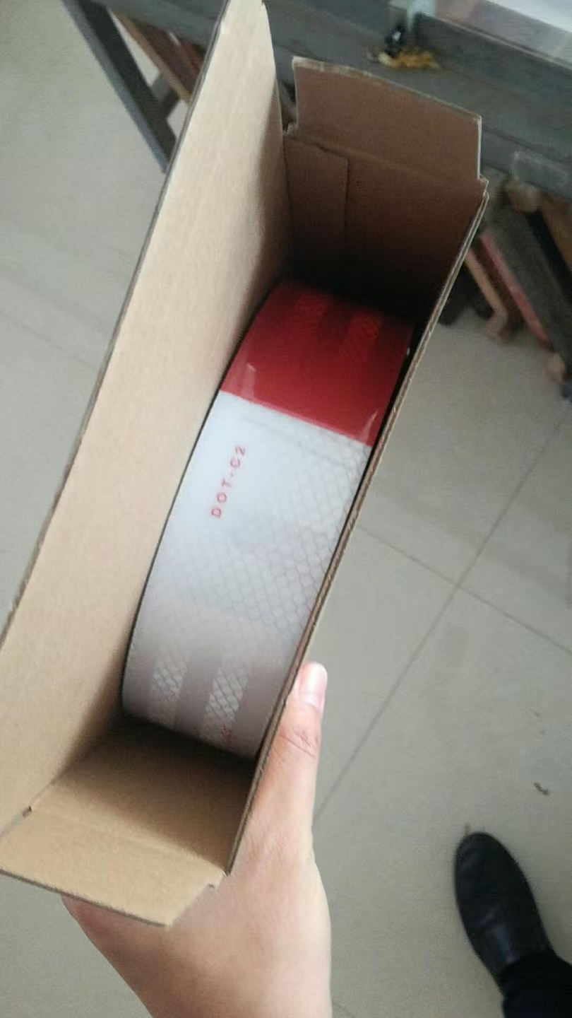 Single red and white DOT-C2 reflective tape roll in an inner carton