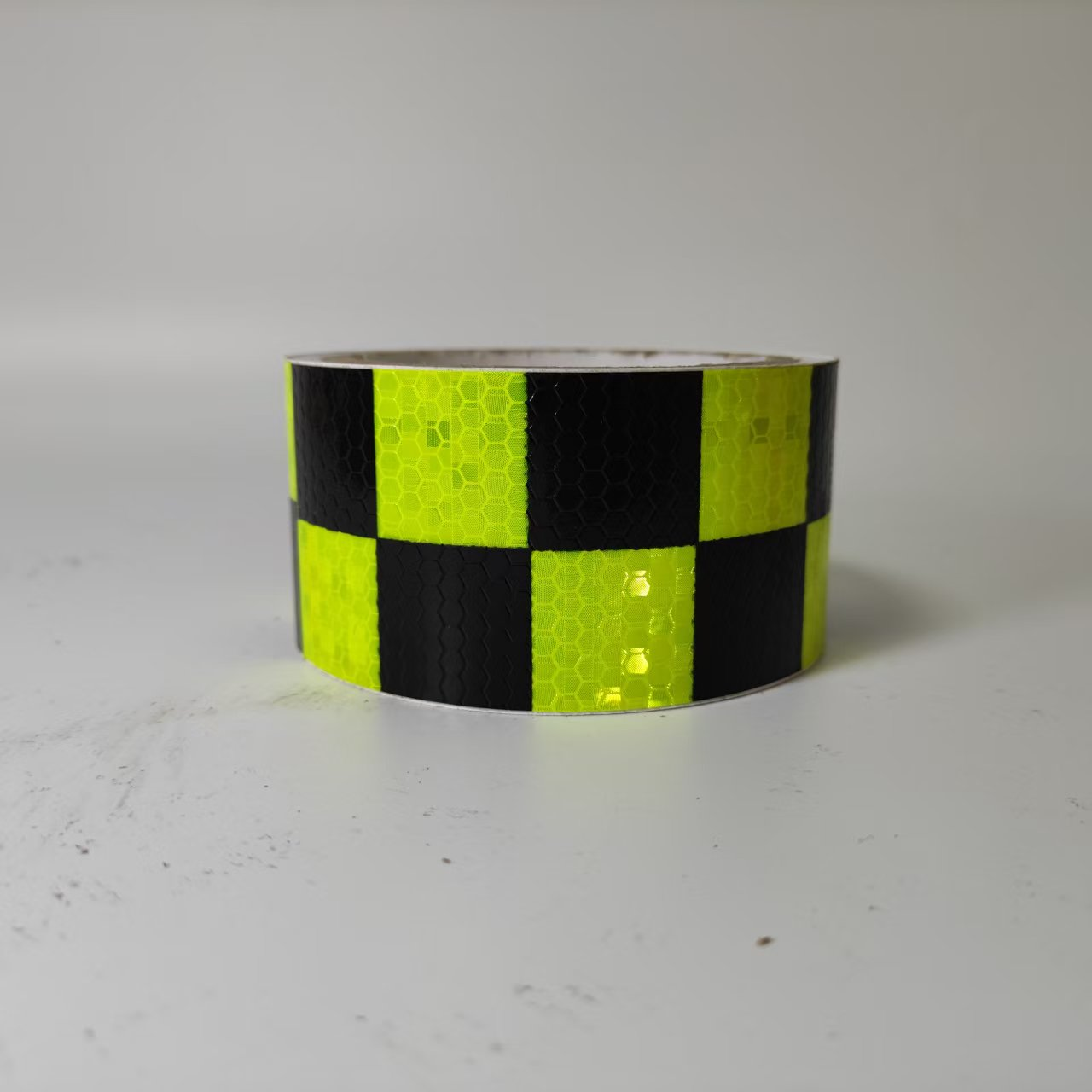 Fluorescent green and black checkerboard reflective tape roll