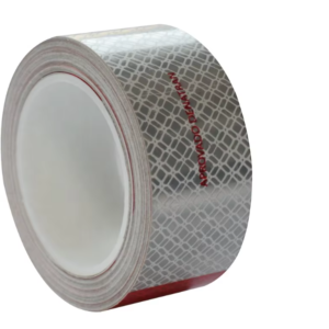 Metallized red and white reflective tape roll side view