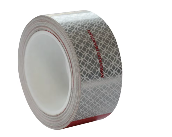 Metallized red and white reflective tape roll side view