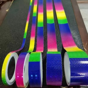 Rainbow reflective tape rolls and strips on a worktable