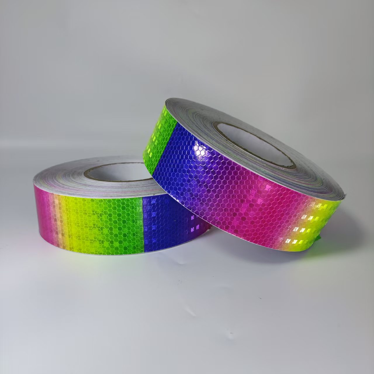 Two rainbow reflective warning tape rolls