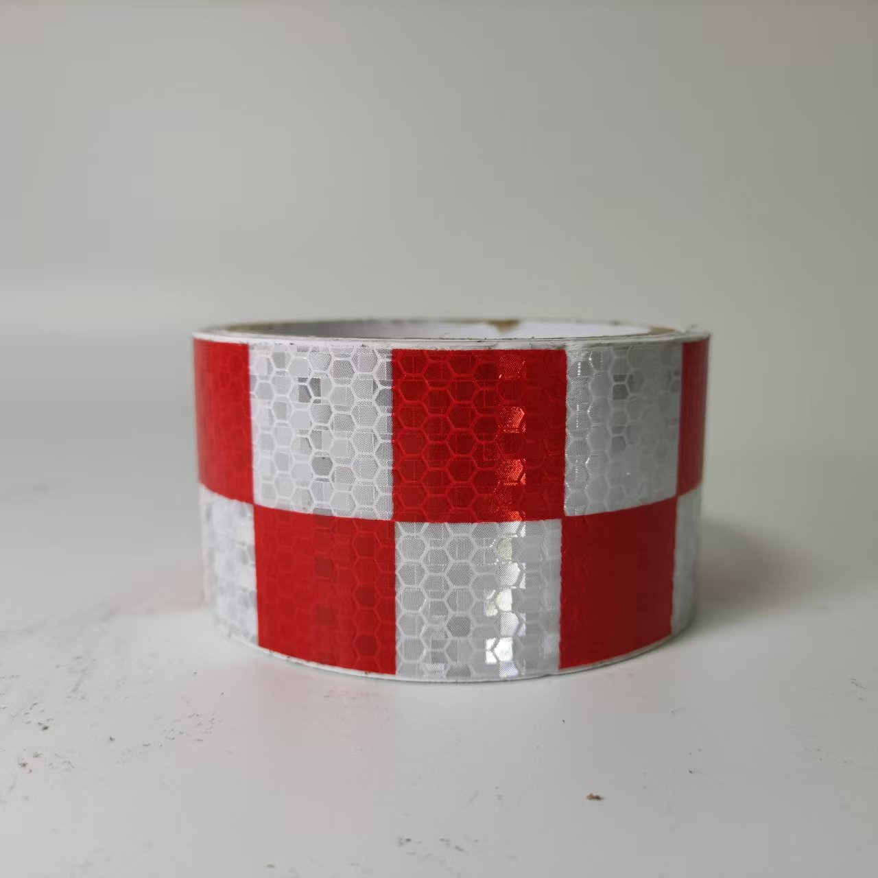 Red and white checkerboard reflective tape roll