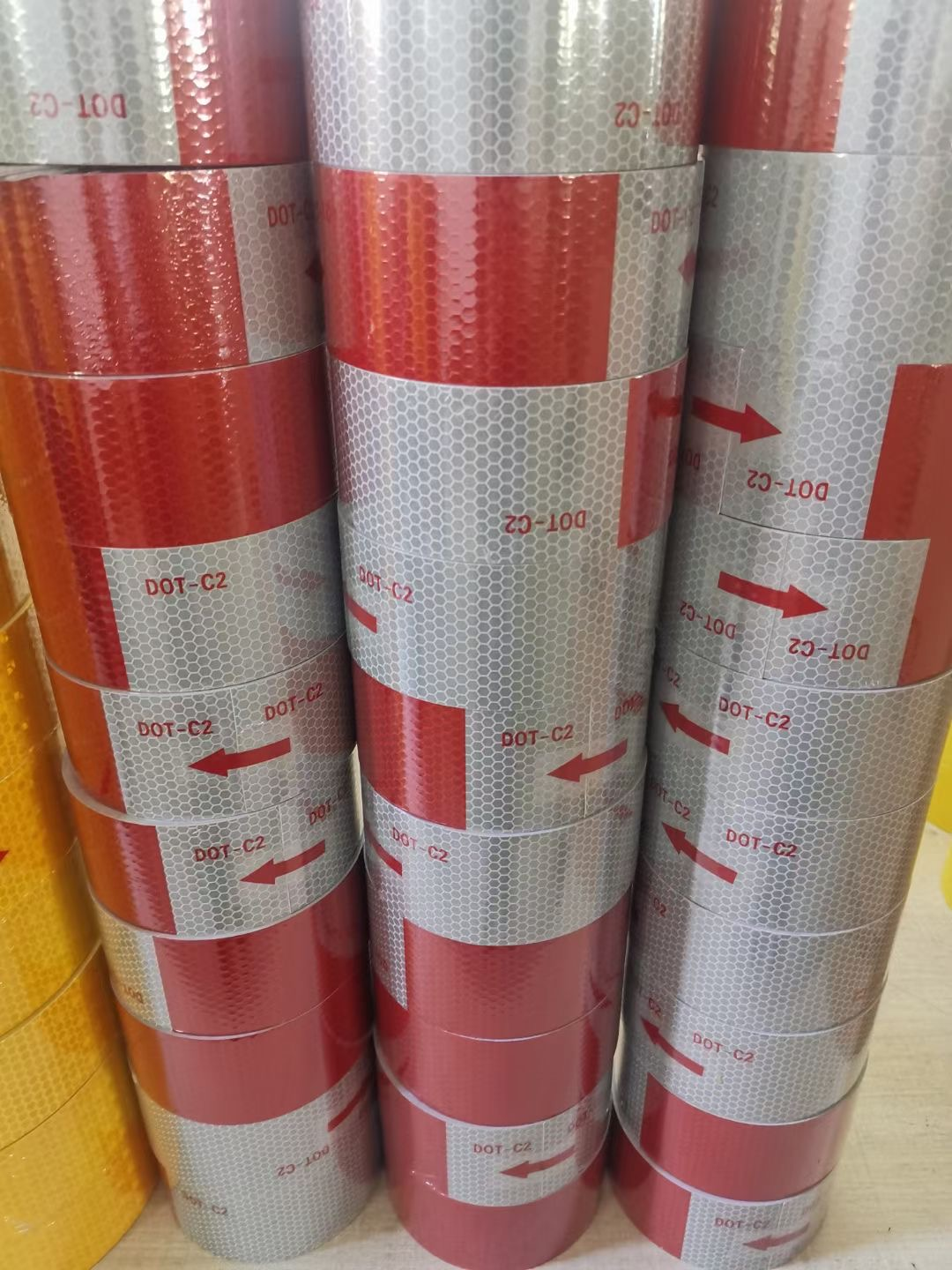 Stacks of red and white DOT-C2 reflective tape rolls