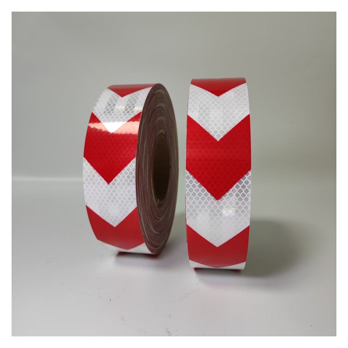 Red and white prismatic arrow reflective tape rolls