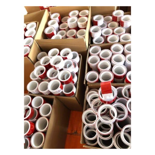 Red and white reflective tape rolls in bulk packing cartons