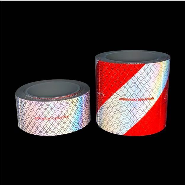 Red and white reflective tape rolls under direct lighting