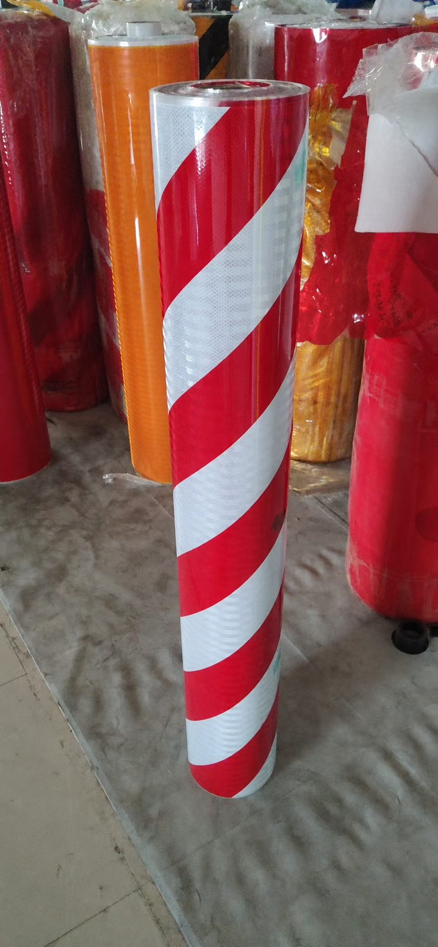 Red and white slant stripe reflective warning tape rolls