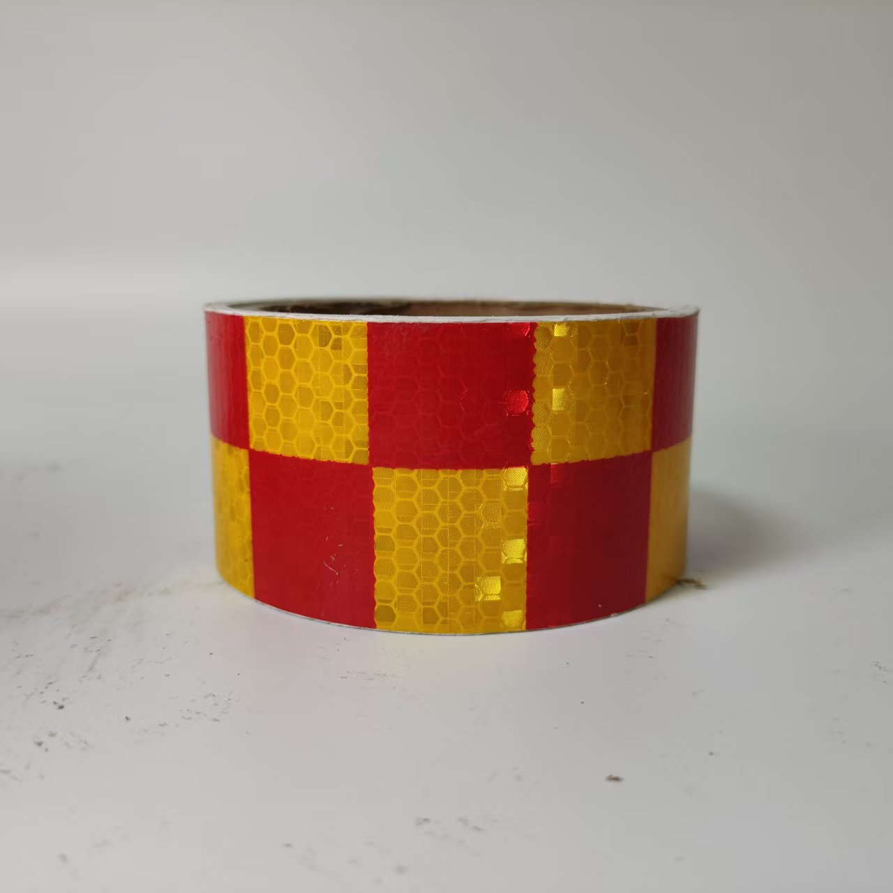 Red and yellow checkerboard reflective tape roll