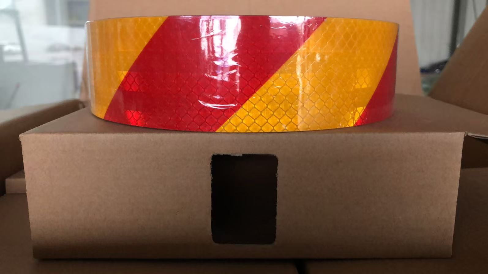 Red and yellow slant reflective warning tape roll