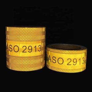 Yellow reflective truck marking tape illuminated against a dark background