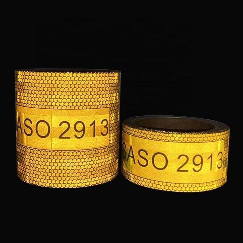 Yellow reflective truck marking tape illuminated against a dark background