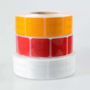 Stacked yellow red and white segmented reflective label rolls