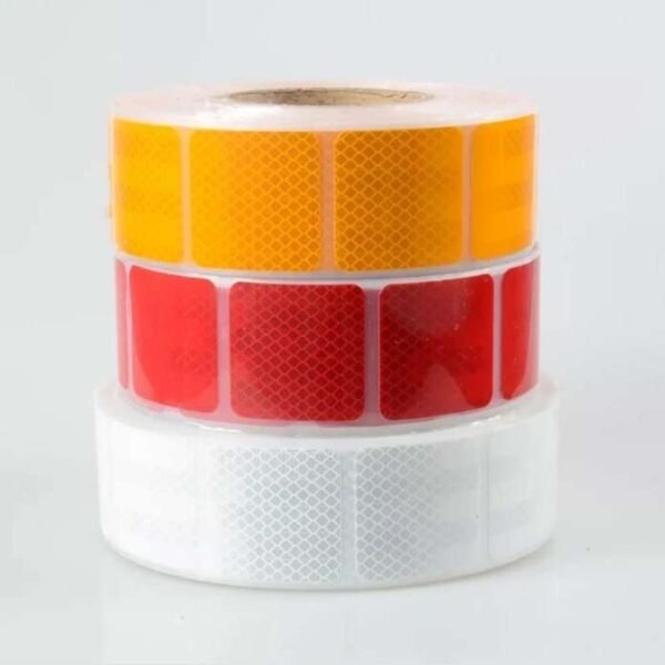Stacked yellow red and white segmented reflective label rolls