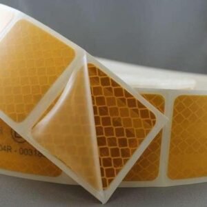 Segmented yellow reflective tape with one section peeled from the liner