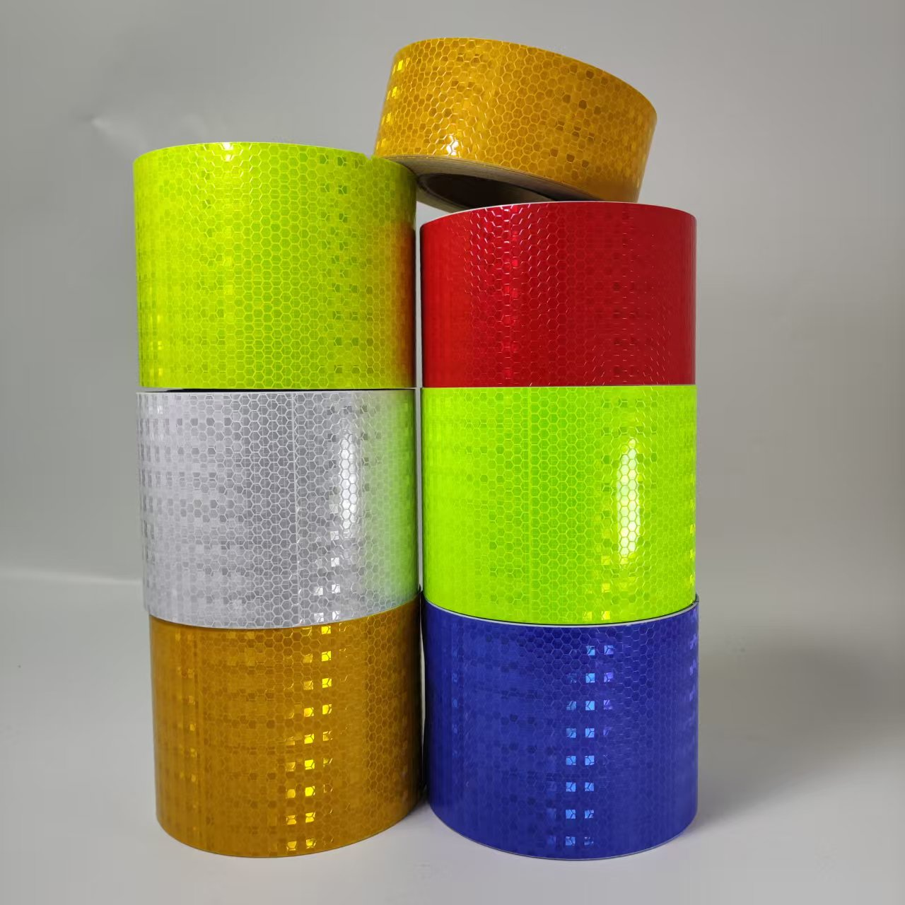 Stacked multi-color honeycomb reflective tape rolls