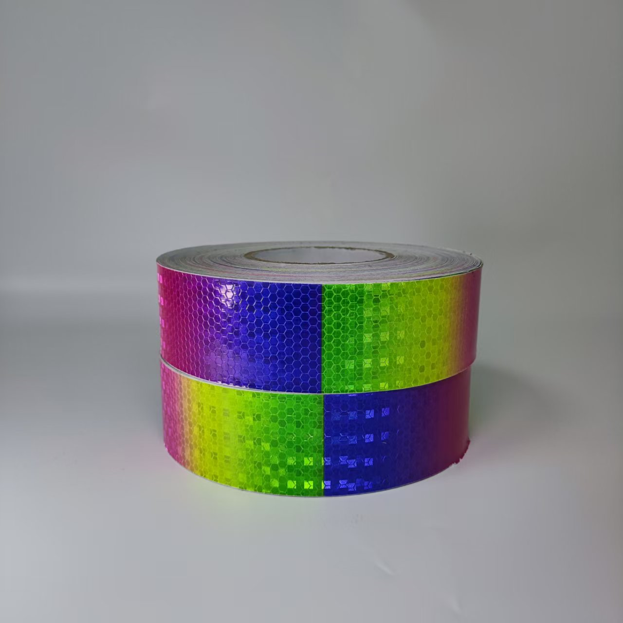 Stacked rainbow reflective tape rolls