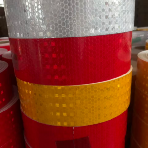 White red and yellow prismatic reflective tape rolls stacked together