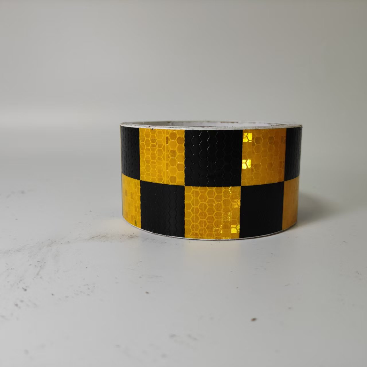 Yellow and black checkerboard reflective tape roll