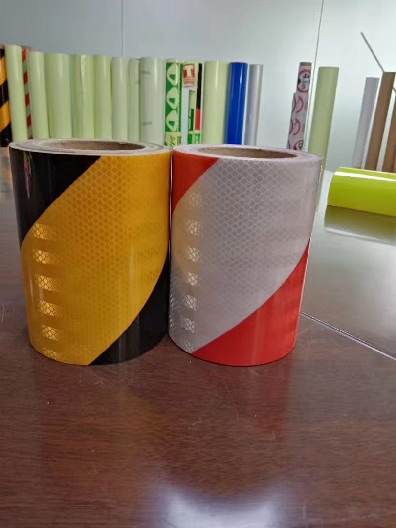 Yellow-black and red-white reflective warning tape rolls