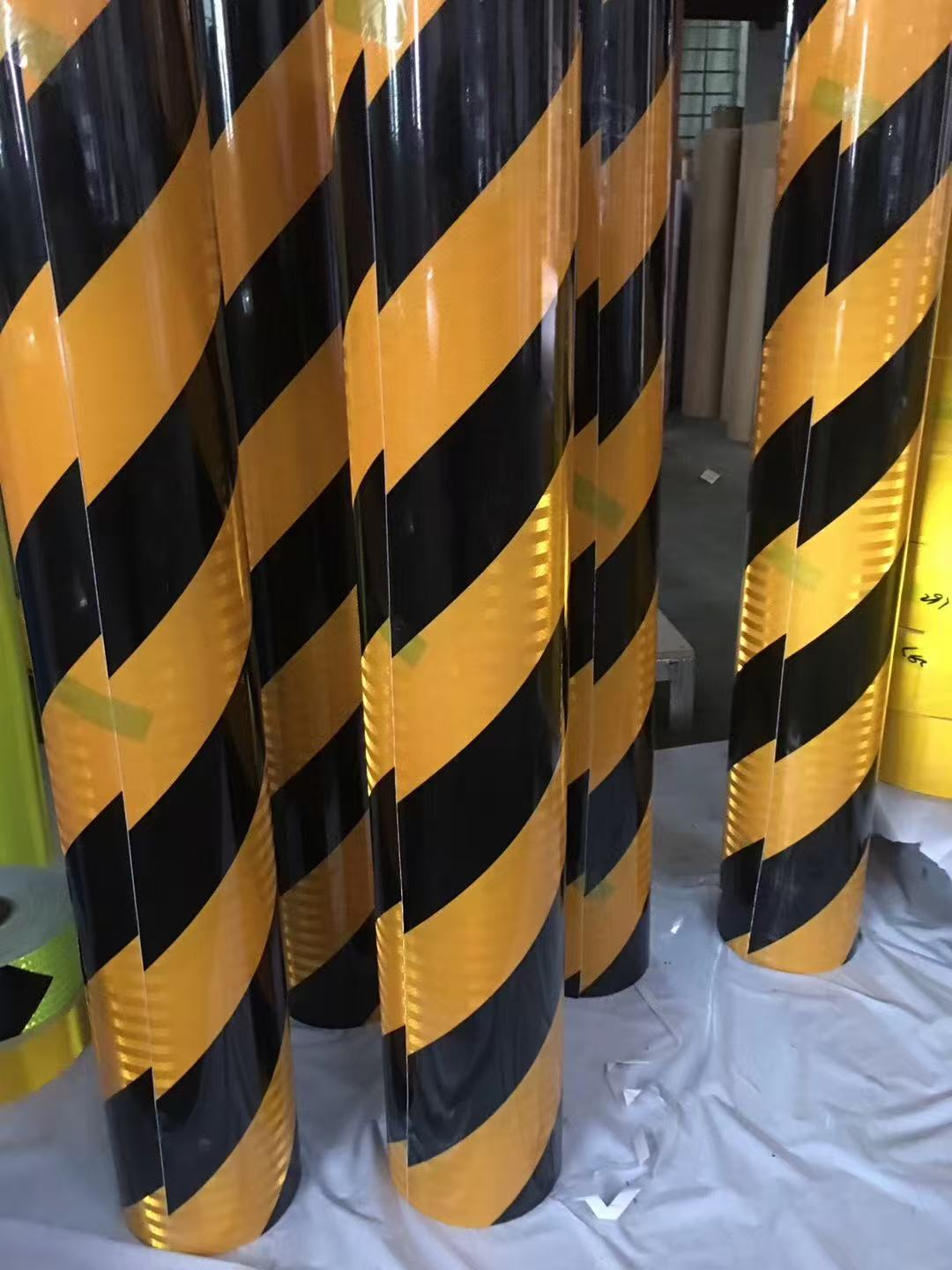 Yellow and black reflective warning tape rolls