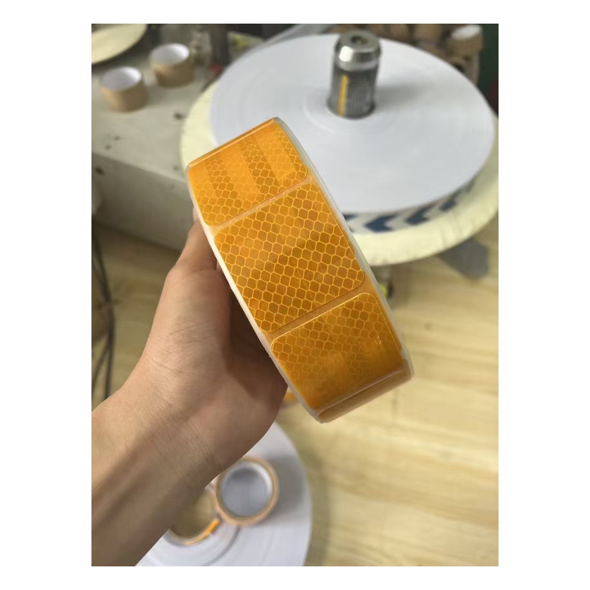 Yellow segmented reflective tape roll during handling