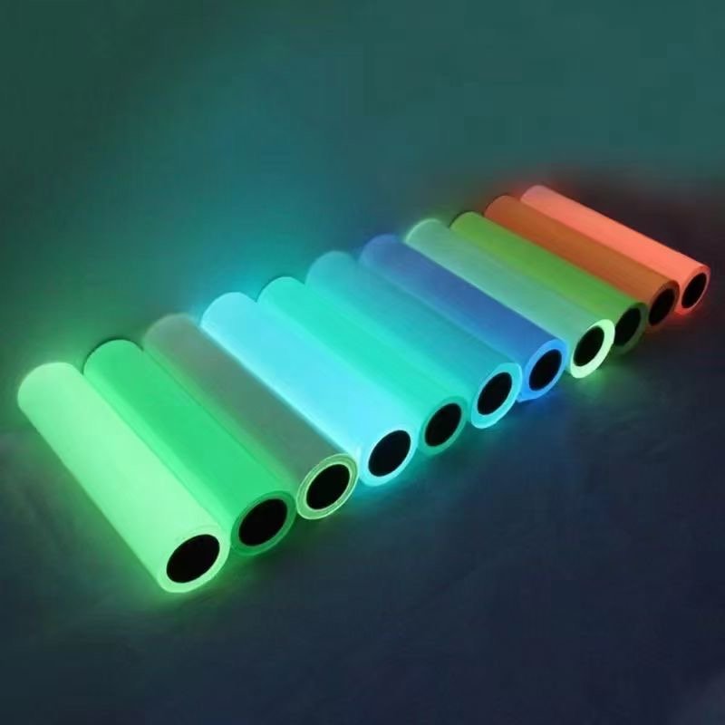 Colored photoluminescent film rolls showing different afterglow colors in darkness