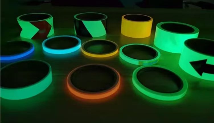 Assorted luminous tape rolls with plain, arrow and diagonal patterns in low light