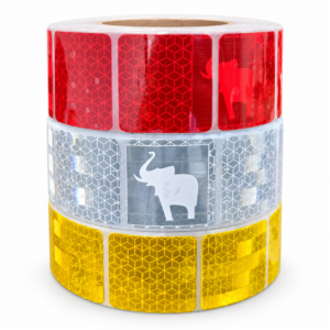 Stacked red, silver white and yellow elephant reflective tape rolls
