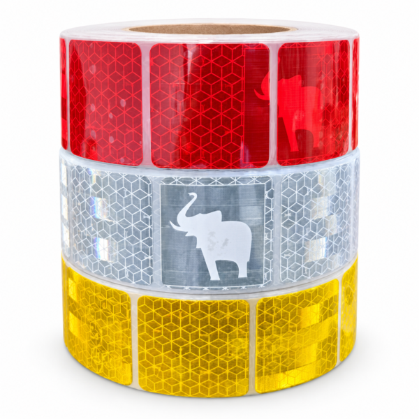 Stacked red, silver white and yellow elephant reflective tape rolls