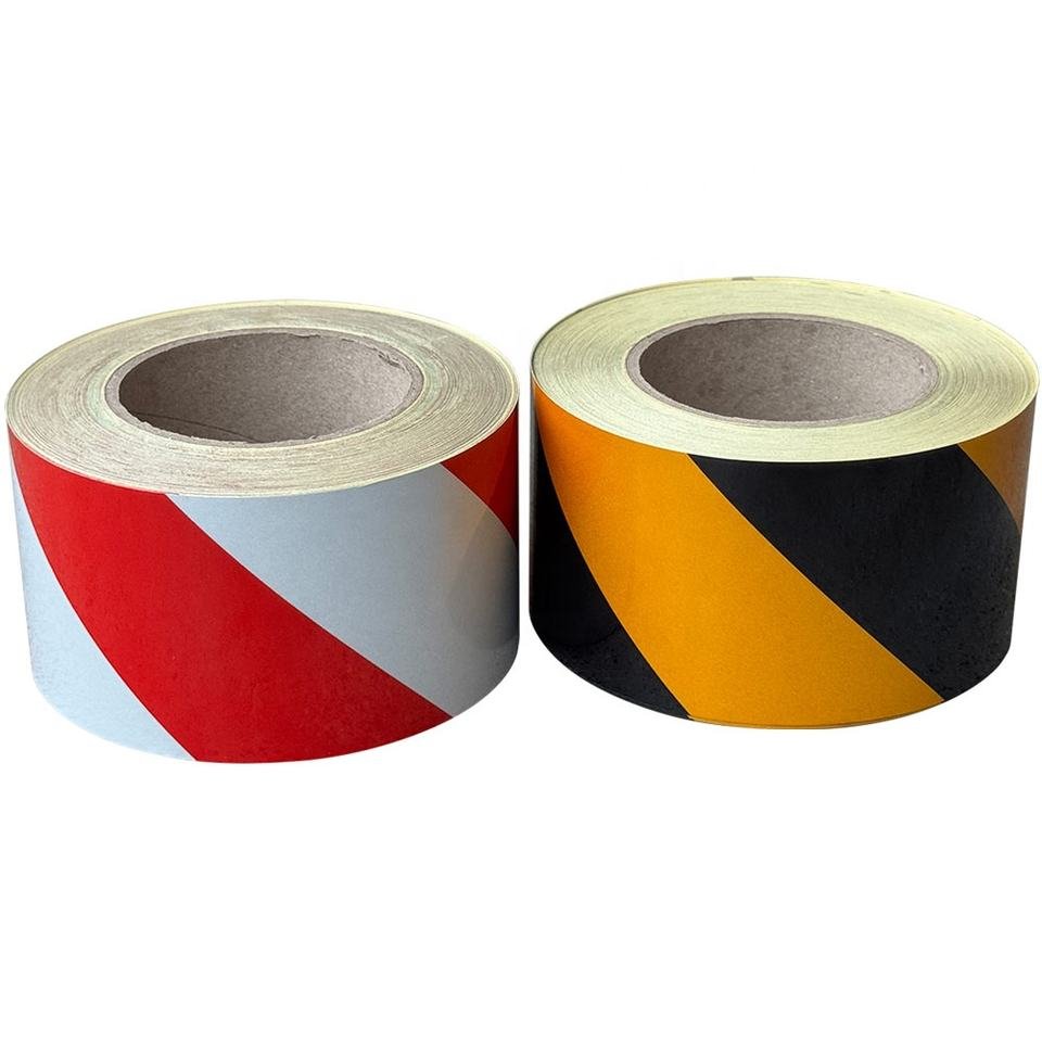 Red and white and yellow and black diagonal warning tape rolls