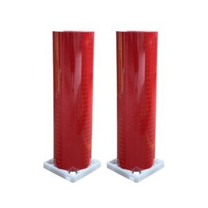 Two red prismatic reflective sheeting rolls on a white background