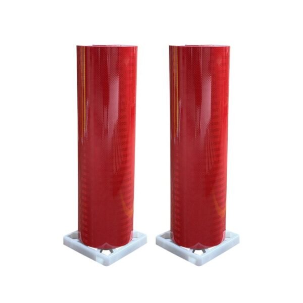 Two red prismatic reflective sheeting rolls on a white background