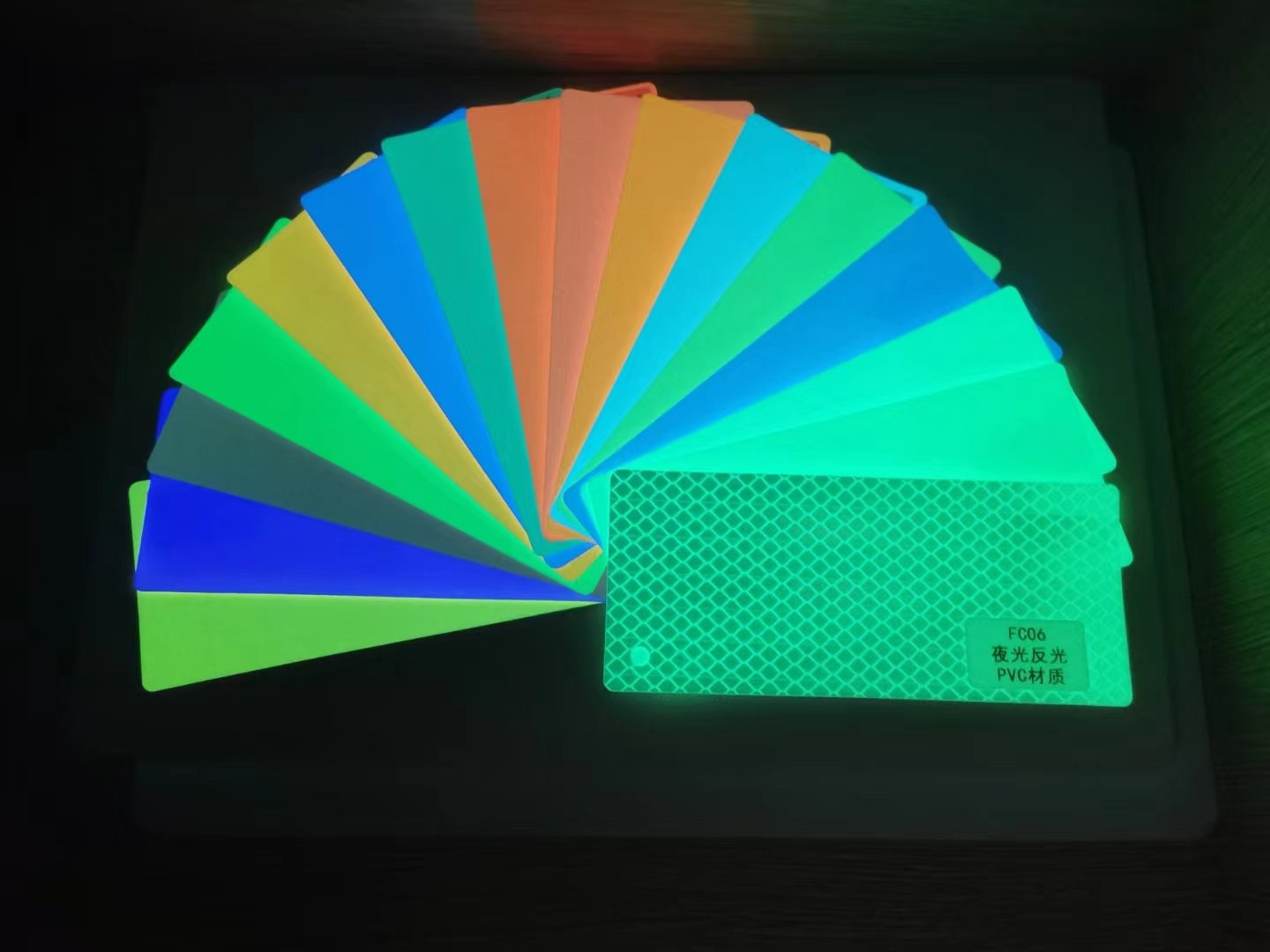 Fan of colored photoluminescent film swatches in different constructions