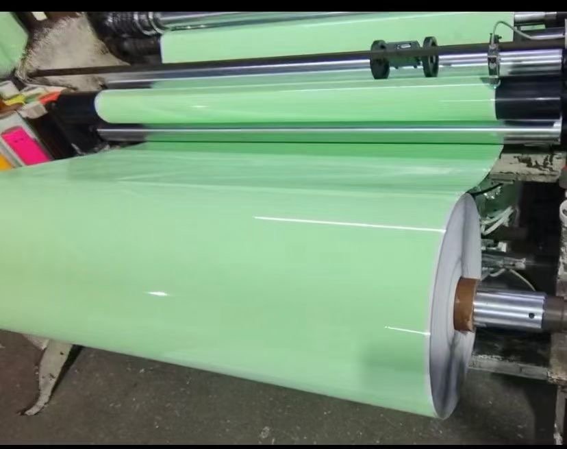 Photoluminescent film passing through production rollers