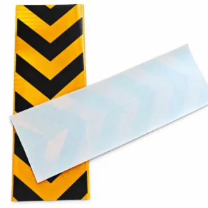 Yellow and black PET chevron sticker with the pale reverse side shown at an angle