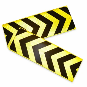 Overlapping yellow and black reflective arrow stickers under incident light
