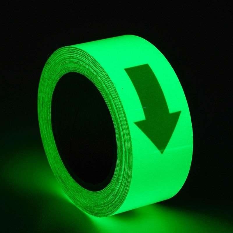 Photoluminescent directional arrow tape showing green afterglow