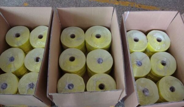 Yellow reflective material rolls individually wrapped inside cartons as a packing reference
