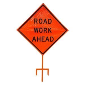 Orange ROAD WORK AHEAD roll-up sign on an in-ground stand