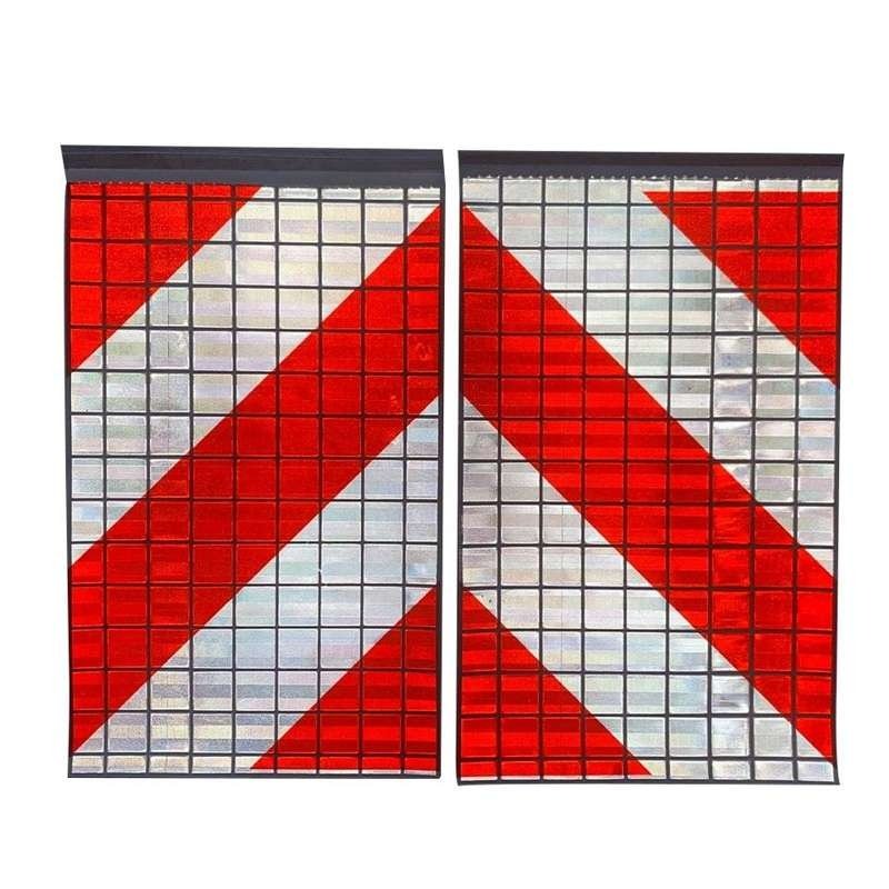 Paired red and white reflective tail lift flags under directed light