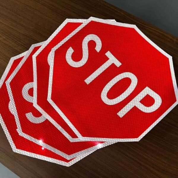 Red and white octagonal reflective STOP sign faces