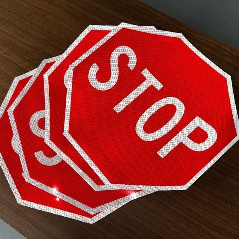 Red and white octagonal reflective STOP sign faces