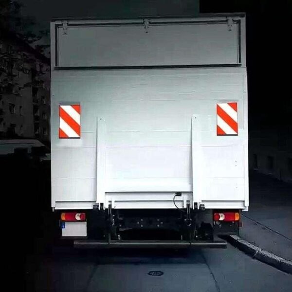 Red and white tail lift marking flags illustrated on the rear of a delivery truck
