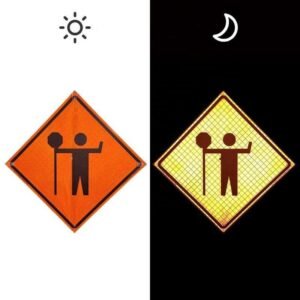Flagger symbol sign shown in daytime and under directed light