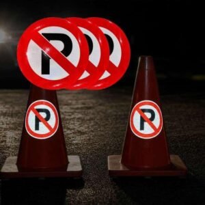 Reflective No Parking stickers on traffic cones under illumination