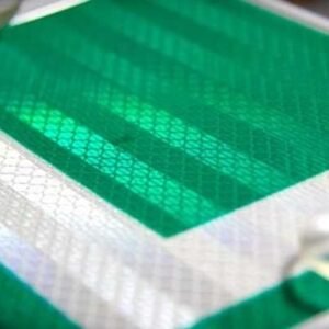 Close-up of green and white reflective L sticker material