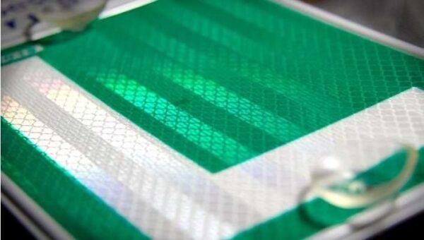Close-up of green and white reflective L sticker material